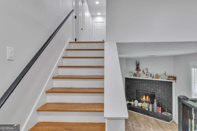 3819 Shane Ct, Ellenwood, GA 30294 - stairway with a fireplace, recessed lighting, and wood finished floors