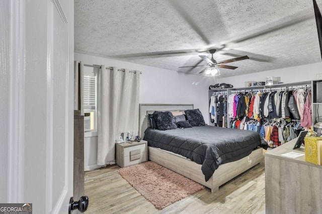 3819 Shane Ct, Ellenwood, GA 30294 - bedroom featuring ceiling fan, a textured ceiling, and wood finished floors