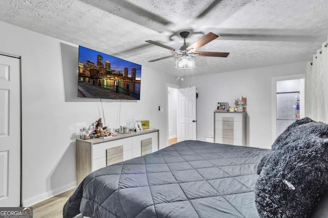 3819 Shane Ct, Ellenwood, GA 30294 - bedroom with ceiling fan, a textured ceiling, baseboards, and wood finished floors