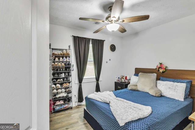 3819 Shane Ct, Ellenwood, GA 30294 - bedroom featuring a textured ceiling, wood finished floors, and ceiling fan