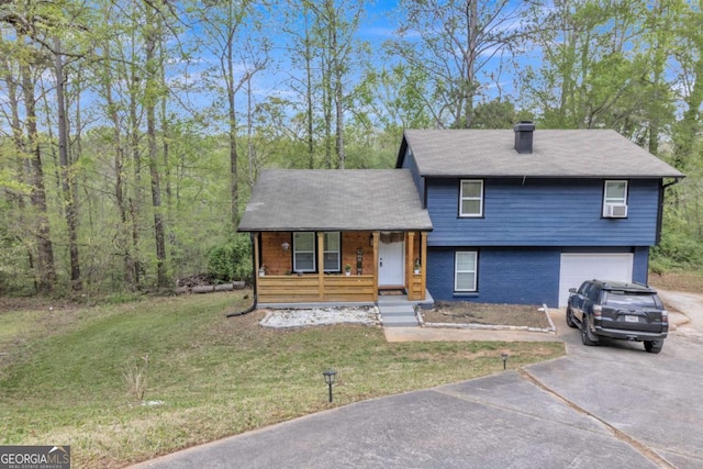 3819 Shane Ct, Ellenwood, GA 30294 - split level home with a chimney, covered porch, an attached garage, a front yard, and aphalt driveway