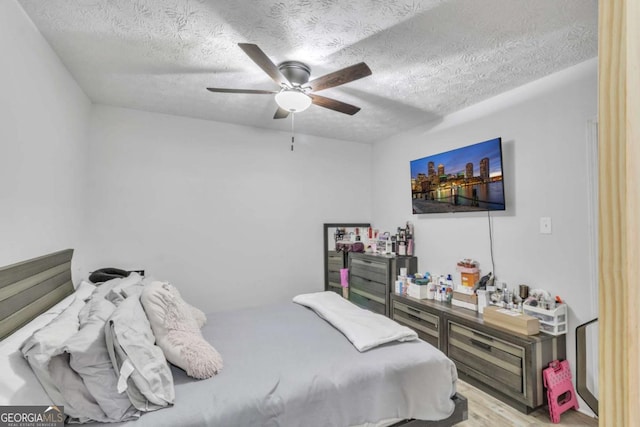 3819 Shane Ct, Ellenwood, GA 30294 - bedroom with a textured ceiling, wood finished floors, and ceiling fan