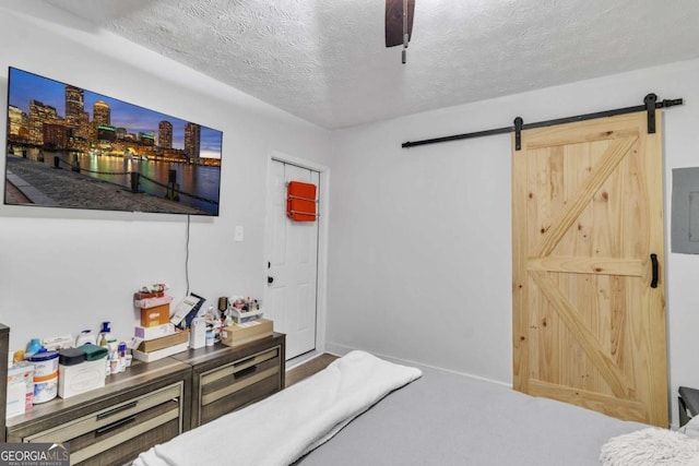 3819 Shane Ct, Ellenwood, GA 30294 - bedroom with ceiling fan, a textured ceiling, carpet flooring, and a barn door