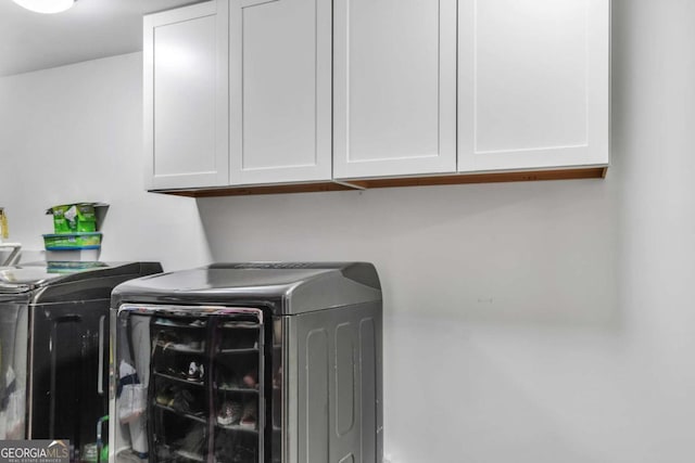 3819 Shane Ct, Ellenwood, GA 30294 - laundry room featuring cabinet space and washing machine and clothes dryer