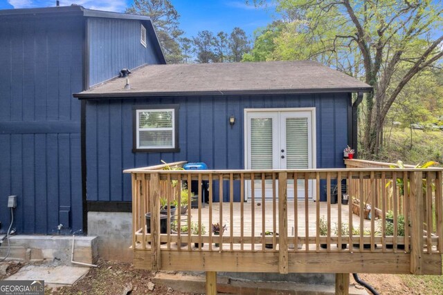 3819 Shane Ct, Ellenwood, GA 30294 - back of house with a shingled roof, board and batten siding, and a deck