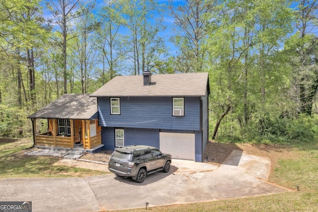 3819 Shane Ct, Ellenwood, GA 30294 - split level home featuring covered porch, roof with shingles, concrete driveway, a garage, and a chimney