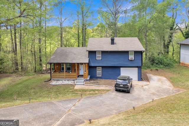 3819 Shane Ct, Ellenwood, GA 30294 - tri-level home featuring concrete driveway, a porch, a front lawn, and an attached garage
