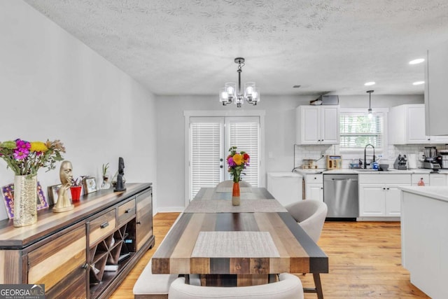 3819 Shane Ct, Ellenwood, GA 30294 - dining space featuring an inviting chandelier, light wood-style flooring, recessed lighting, and a textured ceiling