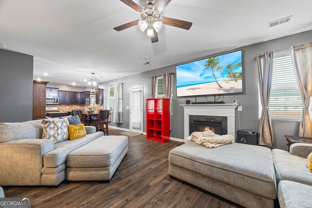 548 Azalea Bloom Dr E, Loganville, GA 30052 - living area with recessed lighting, dark wood-style flooring, a lit fireplace, baseboards, and ceiling fan