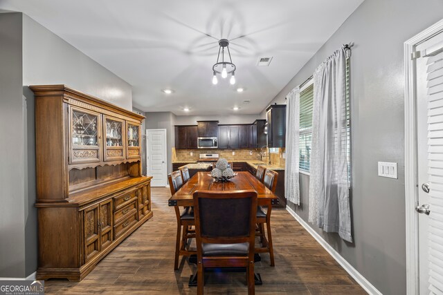 548 Azalea Bloom Dr E, Loganville, GA 30052 - dining space with dark wood finished floors, baseboards, and recessed lighting