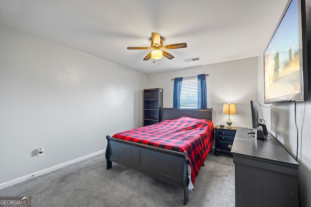 bedroom with light colored carpet, baseboards, and a ceiling fan