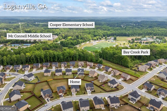 548 Azalea Bloom Dr E, Loganville, GA 30052 - view of property location with nearby suburban area and a heavily wooded area