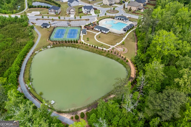 aerial view of a pool and a nearby body of water