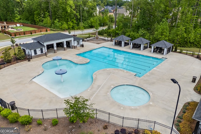 community pool featuring a gazebo, fence, and a patio area