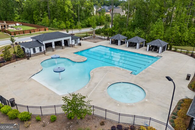 548 Azalea Bloom Dr E, Loganville, GA 30052 - community pool featuring a gazebo, fence, and a patio area