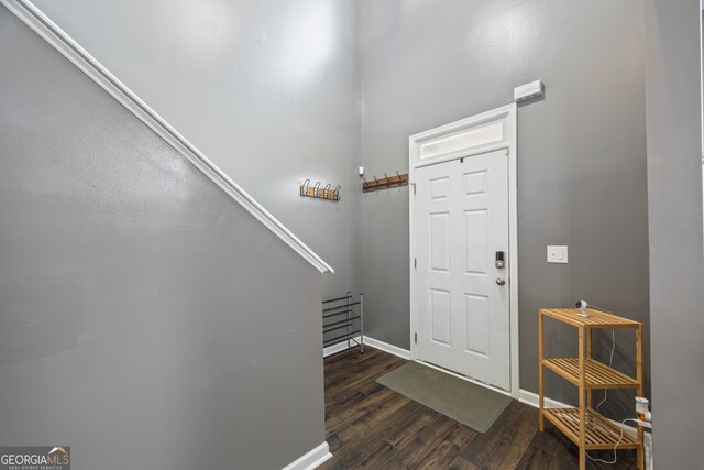 548 Azalea Bloom Dr E, Loganville, GA 30052 - foyer featuring dark wood-type flooring, baseboards, and stairway