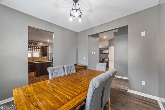 548 Azalea Bloom Dr E, Loganville, GA 30052 - dining area with baseboards and dark wood-type flooring
