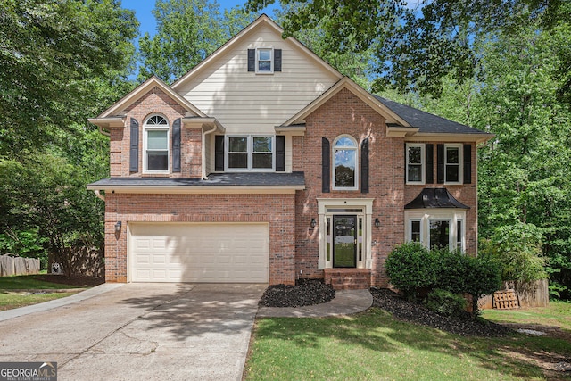 traditional-style home with a garage, concrete driveway, brick siding, and fence