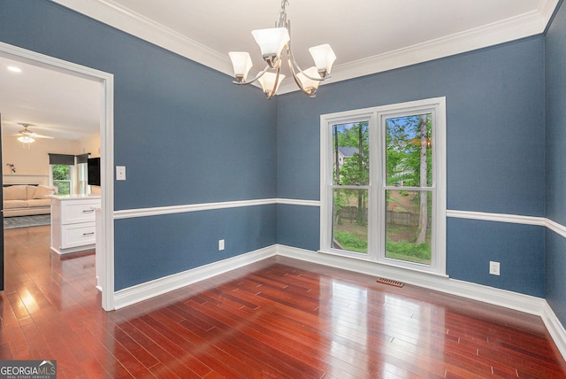 unfurnished room with a chandelier, ornamental molding, baseboards, and hardwood / wood-style floors