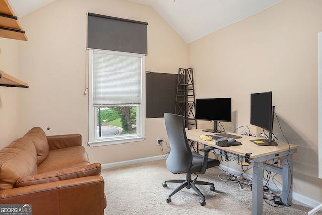 carpeted office space featuring lofted ceiling and baseboards