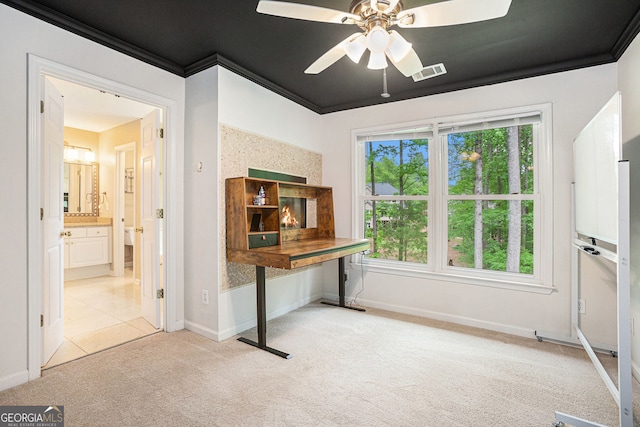 office with light carpet, a ceiling fan, plenty of natural light, baseboards, and crown molding