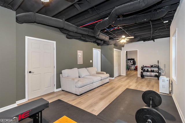 exercise area featuring wood finished floors and baseboards