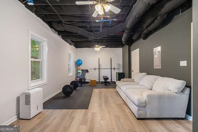 exercise room with ceiling fan, wood finished floors, and baseboards