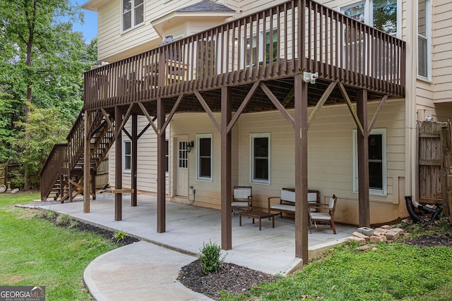 back of house with a deck, a patio, stairway, and a yard