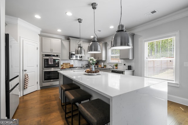 150 Gadson Dr, Fayetteville, GA 30214 - kitchen with stainless steel appliances, gray cabinets, visible vents, decorative backsplash, and ornamental molding