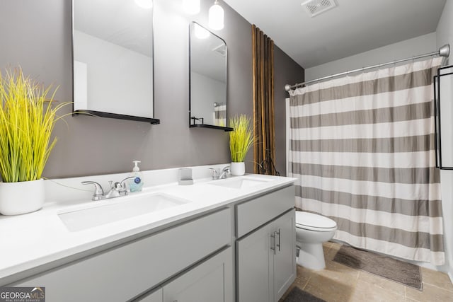 150 Gadson Dr, Fayetteville, GA 30214 - bathroom with double vanity, toilet, visible vents, and a sink