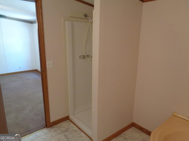 full bath featuring a shower stall, marble finish floor, and baseboards