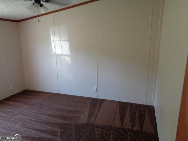 spare room featuring carpet flooring, crown molding, a textured ceiling, and a ceiling fan