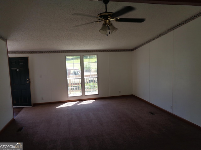 spare room with carpet flooring, a ceiling fan, a textured ceiling, visible vents, and baseboards
