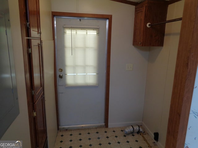 doorway with light floors and baseboards