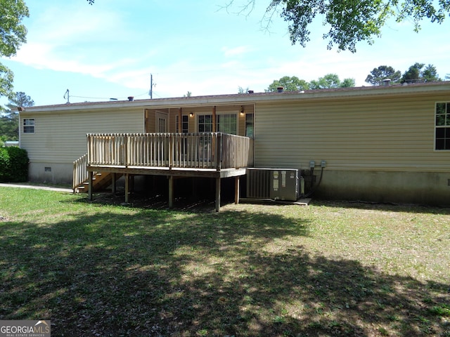 back of property with a yard, cooling unit, a deck, and crawl space