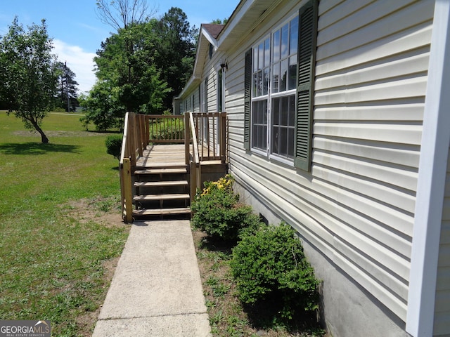 view of home's exterior featuring a lawn and a deck