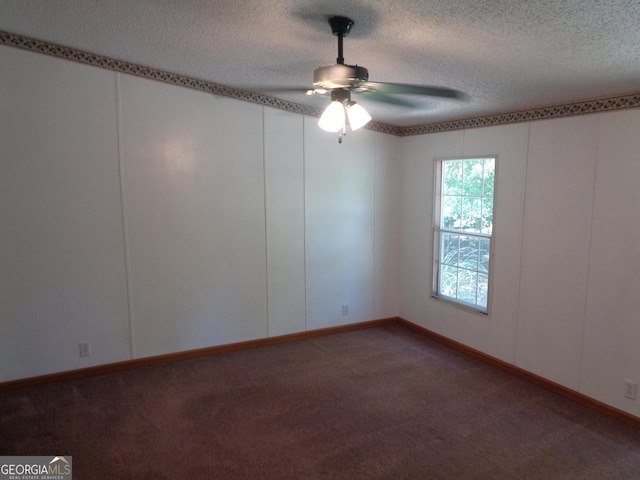 empty room with ceiling fan, a textured ceiling, and carpet