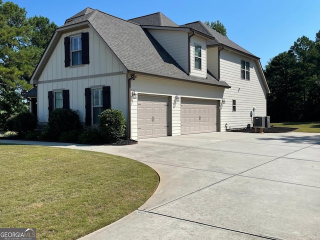 50 Brook Trl, Newnan, GA 30265 - view of side of property featuring roof with shingles, a garage, a lawn, and driveway