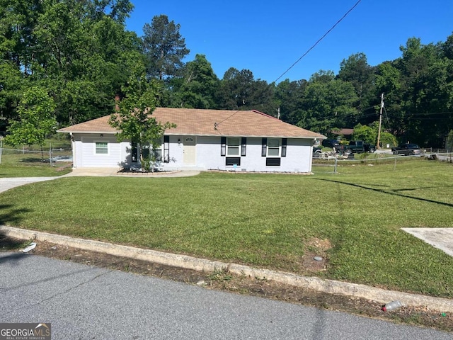 single story home with fence and a front yard