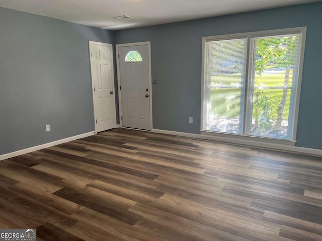 foyer entrance featuring baseboards, plenty of natural light, and wood finished floors