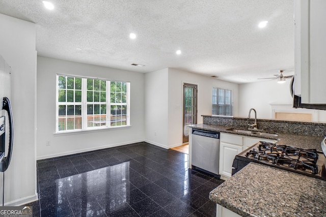 3550 Willow Tree Trce, Decatur, GA 30034 - kitchen featuring stainless steel dishwasher, a sink, recessed lighting, baseboards, and white cabinetry