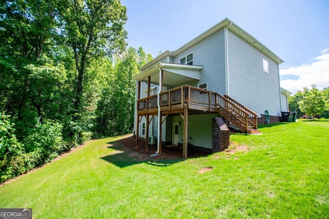 rear view of house featuring a wooden deck, a lawn, and stairway