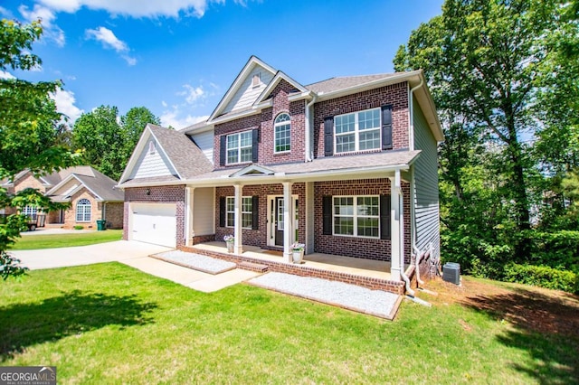 view of front of property featuring covered porch, driveway, brick siding, and a front yard