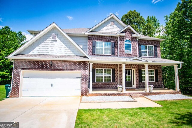 view of front of property featuring brick siding, driveway, an attached garage, covered porch, and a shingled roof