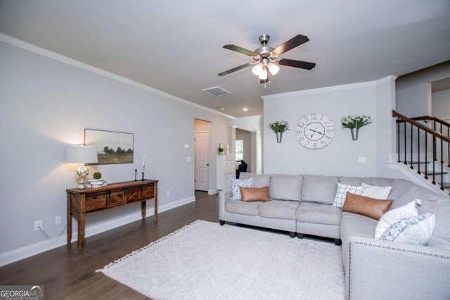 living room with ceiling fan, ornamental molding, wood finished floors, stairs, and baseboards