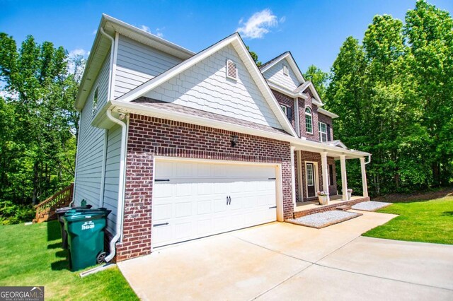 view of property exterior with concrete driveway, brick siding, a garage, and a yard