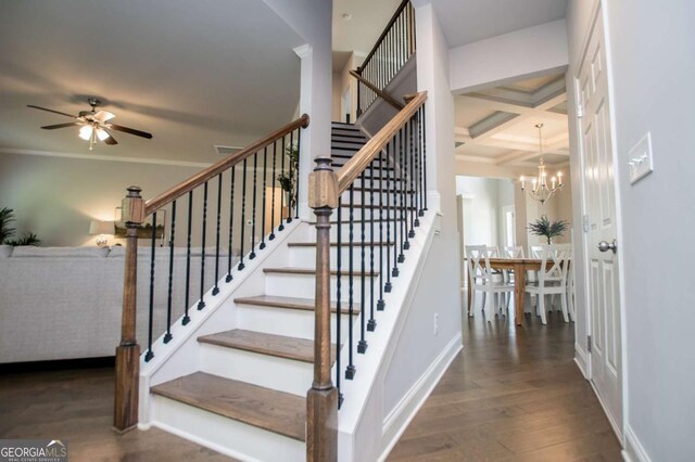 stairs featuring coffered ceiling, ceiling fan, crown molding, wood finished floors, and beam ceiling