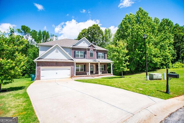 view of front facade with covered porch, driveway, brick siding, and a front lawn