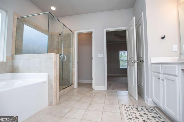 bathroom with tile patterned floors, a shower stall, a bath, vanity, and recessed lighting