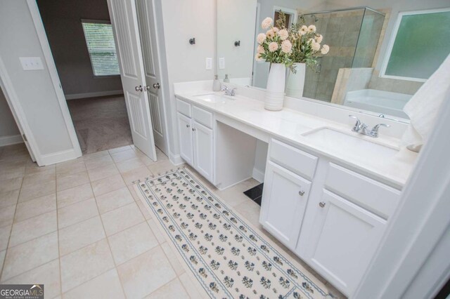 full bathroom with a stall shower, tile patterned flooring, double vanity, a garden tub, and baseboards